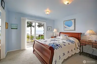 Spacious primary bedroom w/ slider doors to deck...