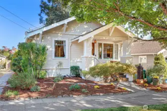 A pretty garden adorns the front walkway.