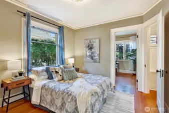 The primary bedroom offers a large, light-filled window, walk-in closet, & en-suite office/nursery/3rd bedroom.