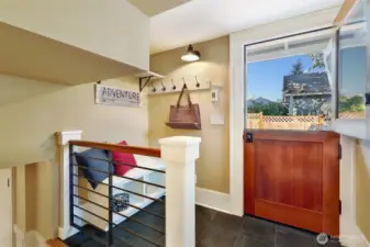 Dutch door mud room with custom storage bench & hangers.