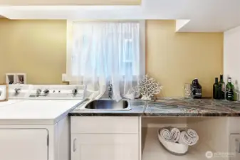 Utility sink & storage cabinets make laundry day a breeze. Laundry space can double as a wet bar for lower level entertaining!