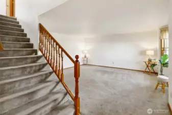 The living room is located to the right of the front door.