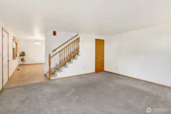 The kitchen and dining room is to the left of the front door.