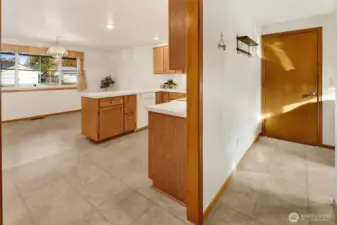 The laundry room is right behind the kitchen.
