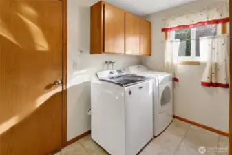 Generous laundry room is the pass though to the garage.  A large storage closet is also located here.