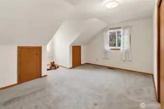 Bedroom 2 with a dormer window and 2 fun little storage doors perfect for "secret forts"