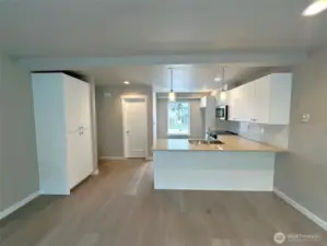 Open living and kitchen area with pantry to the left