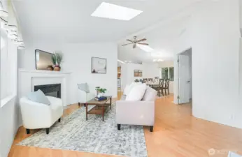 Entry with coat closet to the right of frame, living room opens to the dining area, with a doorway leading to the office.