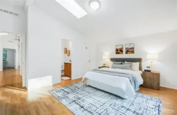 Living area to spacious primary bedroom w/ 3/4 bath and walk-in closet.