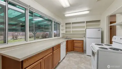 Kitchen with large picture windows overlooking the backyard