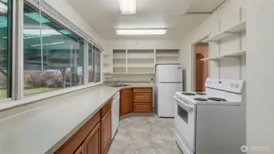 Kitchen with large picture windows overlooking the backyard