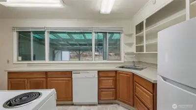 Kitchen with large picture windows overlooking the backyard