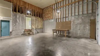 Double-height attached 24' wide x 28' deep garage with 10' garage door and alley access.