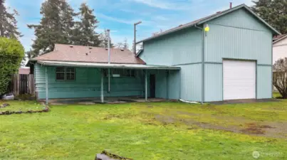 Large level backyard with alley access to double height garage with 10' garage door