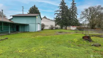 Large level backyard with alley access to double height garage with 10' garage door