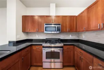 Granite countertops, plentiful cabinetry, and stainless appliances create a kitchen that’s as beautiful as it is practical