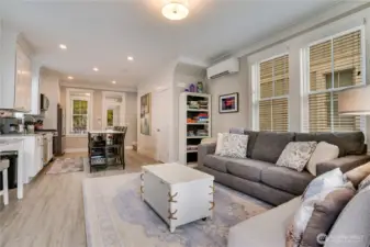 Offered furnished at the list price, the living room includes a sofa that folds out into a queen bed. A ductless heat pump with air conditioning provides year-round comfort, and tall windows fill the space with natural light.