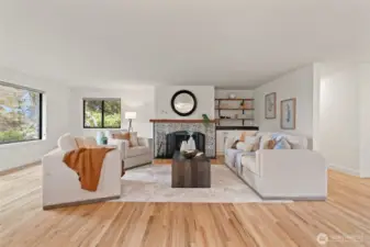Living room with fireplace and hardwood floors.