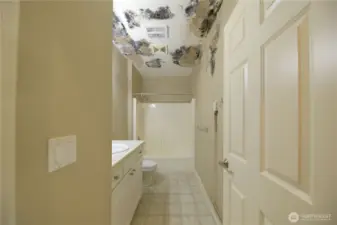 Hallway bath. Spongy floor. Something on the ceiling.