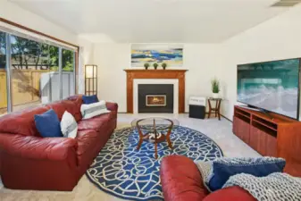 Large family room with a gas fireplace perfect for a cozy winter movie night.