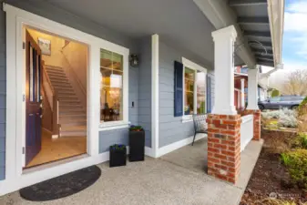 Sweet front porch with brick pillars.