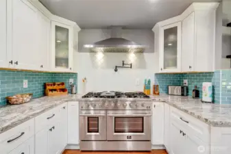 Forno range - 48 inches, 8 burners, two ovens - professional styling and performance. Pot filler, SS hood vent and tile full height backsplash.
