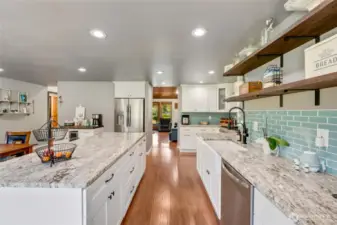 Large island with cabinetry on both sides.  Views front to back of the house. LVP flooring throughout the house. New interior doors. New windows. Four mini-splits. 25 KW generator.  New electrical panel.