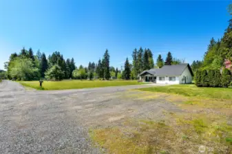 Additional parking in front. Road maintenance agreement for gravel road. Garage converted during COVID to a work/family space - garage doors are still present.