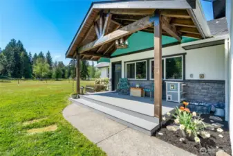 Covered porch with composite decking, chandelier, new window package, new paint (2024), composite roof (2019) gutters (2021).  Come sit and enjoy the peace, quiet, and mountain views.