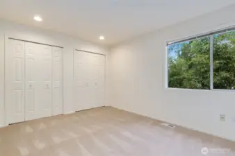 Spacious and versatile third bedroom with dual closets and a large window. Fresh carpet, recessed lighting, and neutral tones make it a perfect blank canvas for any style or use.