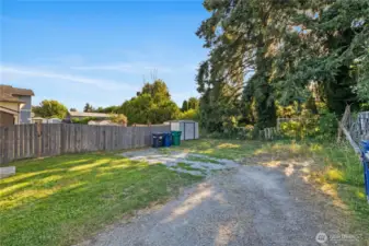 Large parking area, room for trash & recycle bins and metal storage shed for yard maintenance and/or sports or seasonal equipment