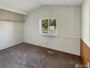 Guest bedroom located opposite the primary bedroom in this split-bedroom floor plan.