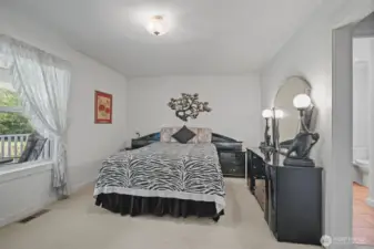 Primary bedroom at front of home with walk in closet and bath