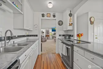 Kitchen with new appliances looking at living room