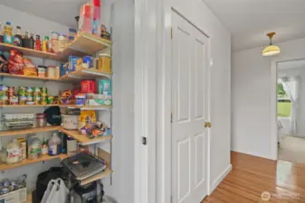 Pantry and door to laundry, second bedroom and  garage entrance through hallway