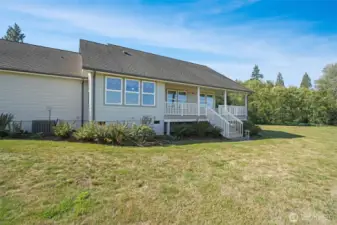 Rear of home with large deck for sitting  and taking in the sunsets!