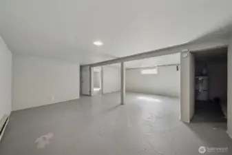 Rec room in basement - notice the additional storage room with water heater on the right.