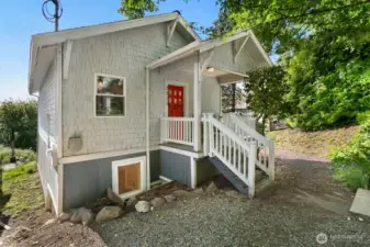 Charming from every angle! This freshly painted cottage greets you with a welcoming front porch, bold red door, and lower-level windows hinting at the spacious, fully finished basement below.