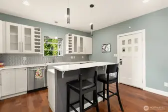 Stainless steel appliances and modern light sconces set a calming mood for your main gathering space.