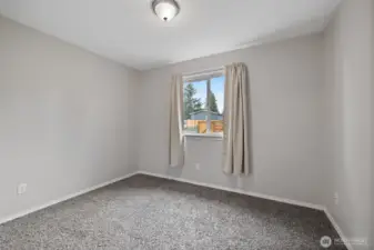 Bedroom #2, to the right of the laundry room and at front of home