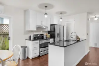 Lovely remodeled kitchen with slab granite counters, SS appliances and walk-in pantry.
