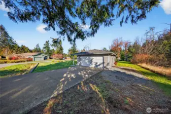 Spacious driveway and attached garage offer convenience and ample parking.