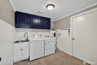 Spacious utility room with easy access to garage and kitchen.