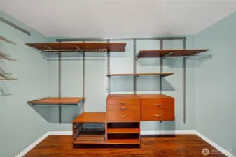 Spacious primary walk-in closet with custom built-ins for effortless organization.
