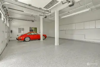 This garage is a must see with expoxy floor and lots of storage in cabinets and overhead. Convenient door into the side yard. The Porsche is not included in sale. ;)