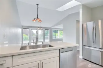 Vaulted ceilings, skylights, and window coverage makes this home shine bright.