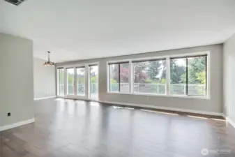 Great room on main floor. Check out the window coverage and the plexiglass-railed deck.