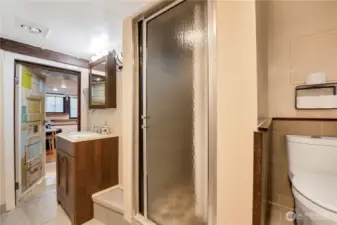 Artist unit bathroom. Shower has river rock floor and rainfall shower head.