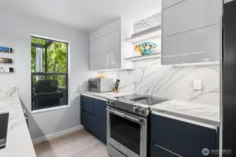 This modern kitchen boasts custom cabinets, high-end countertops, premium appliances, and a sleek backsplash—where style meets function.