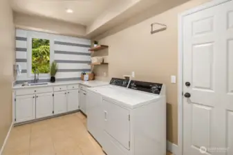 Remodeled laundry room with new quartz counters and tiled back wall. Open shelving for Pinterest worthy storage! Washer and dryer go with seller.
